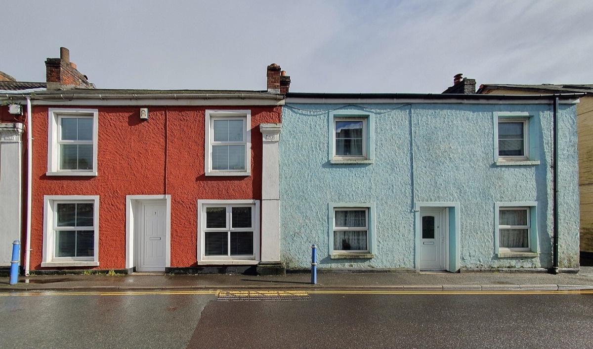 A row of colourful terraced houses on a residential street in Cornwall