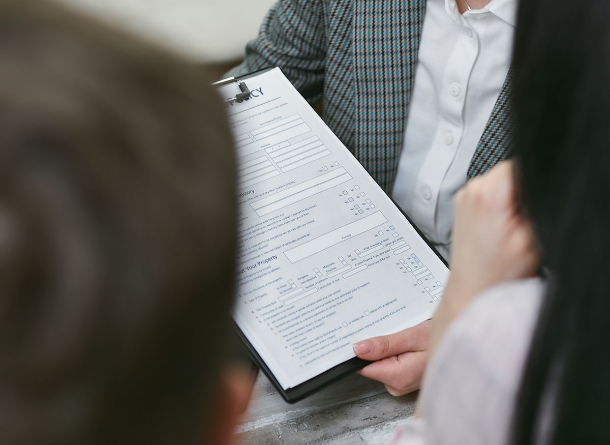 Close-up of a person reviewing documents on a clipboard